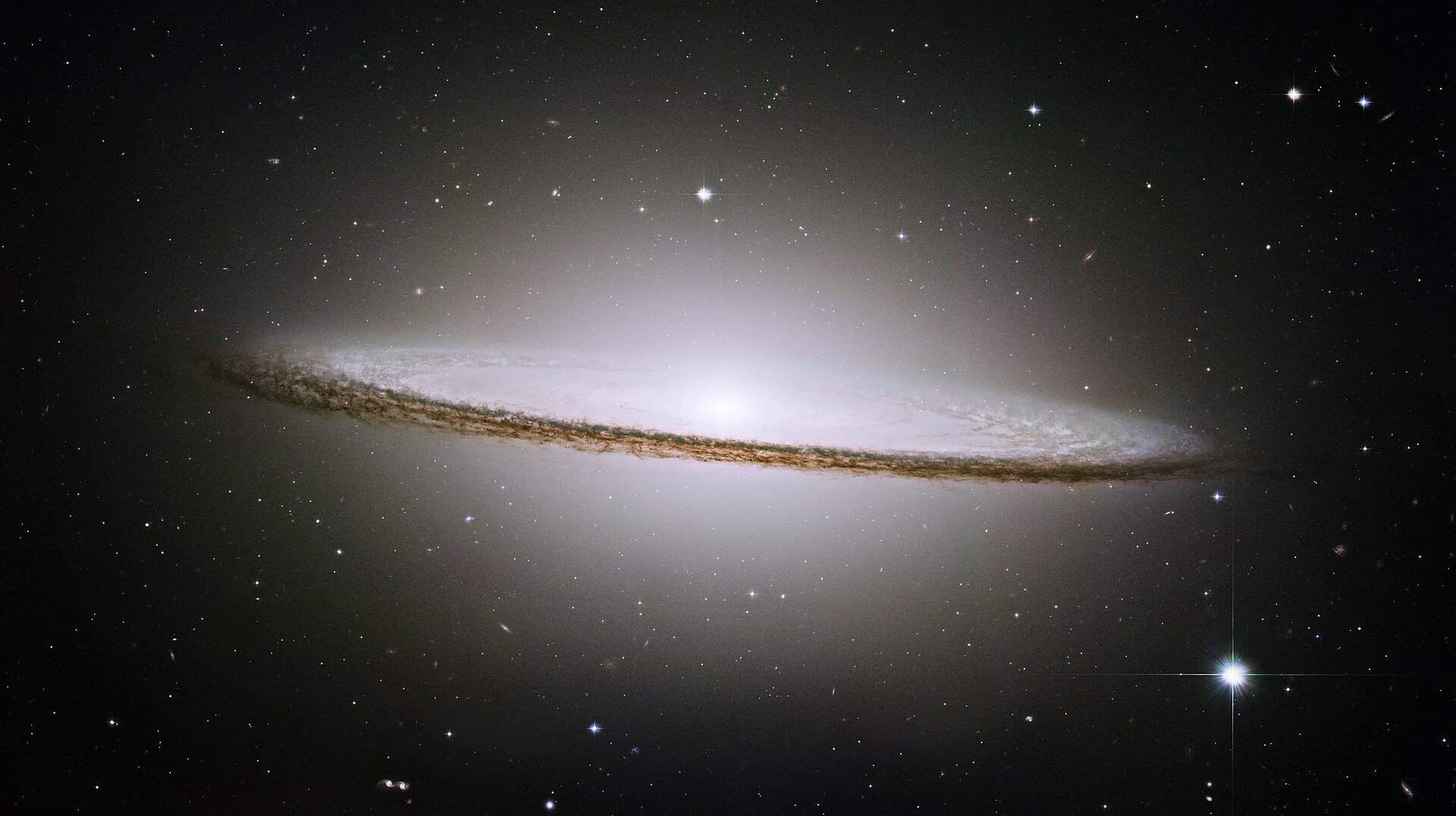 The famous Sombrero galaxy (M104) is a bright nearby elliptical galaxy. The prominent dust lane and halo of stars and globular clusters give this galaxy its name. Something very energetic is going on in the Sombrero's center, as much X-ray