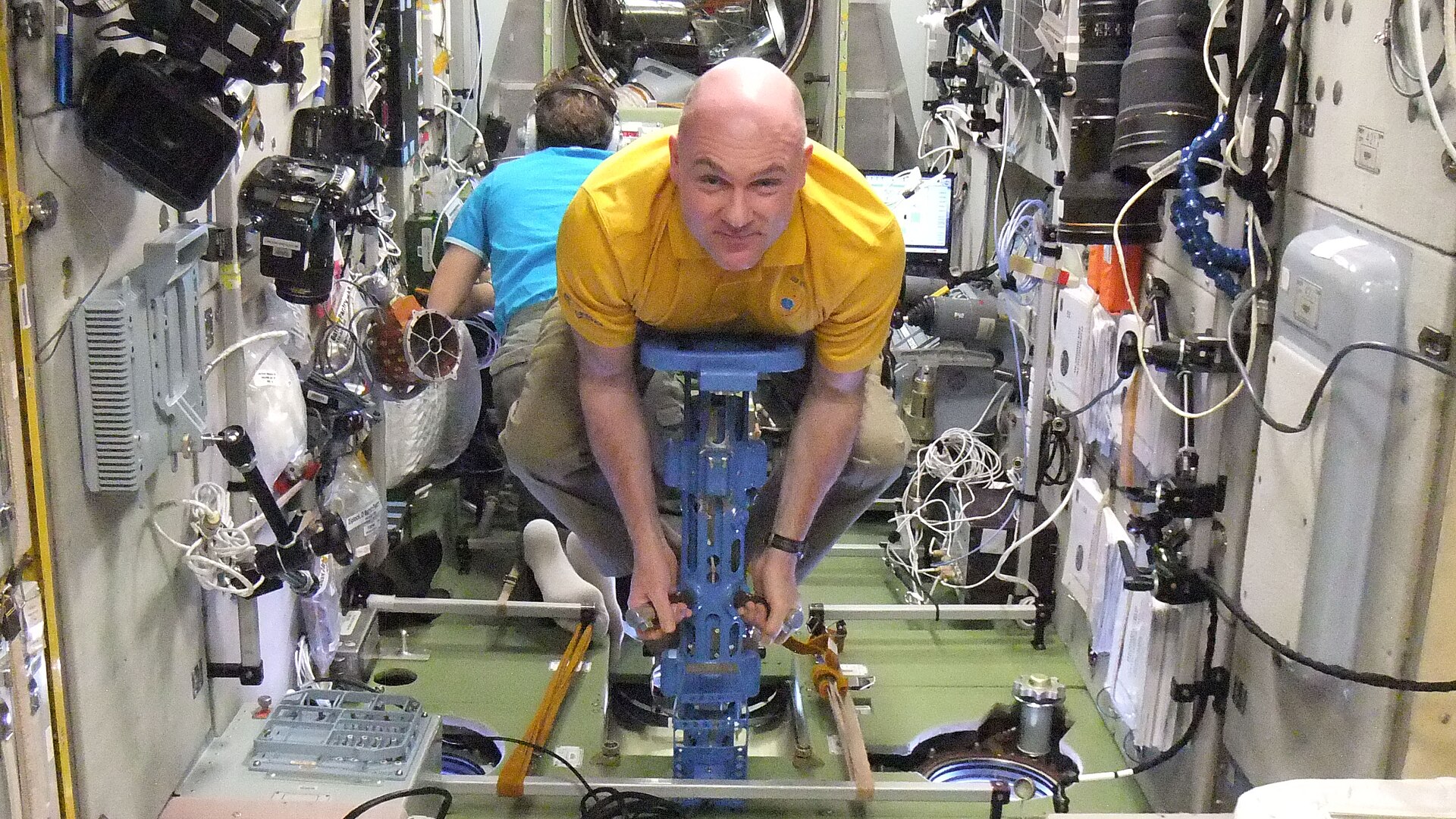 European Space Agency astronaut Andre Kuipers, Expedition 31 flight engineer, uses a body mass measurement device (BMMD) in the Zvezda Service Module of the International Space Station.