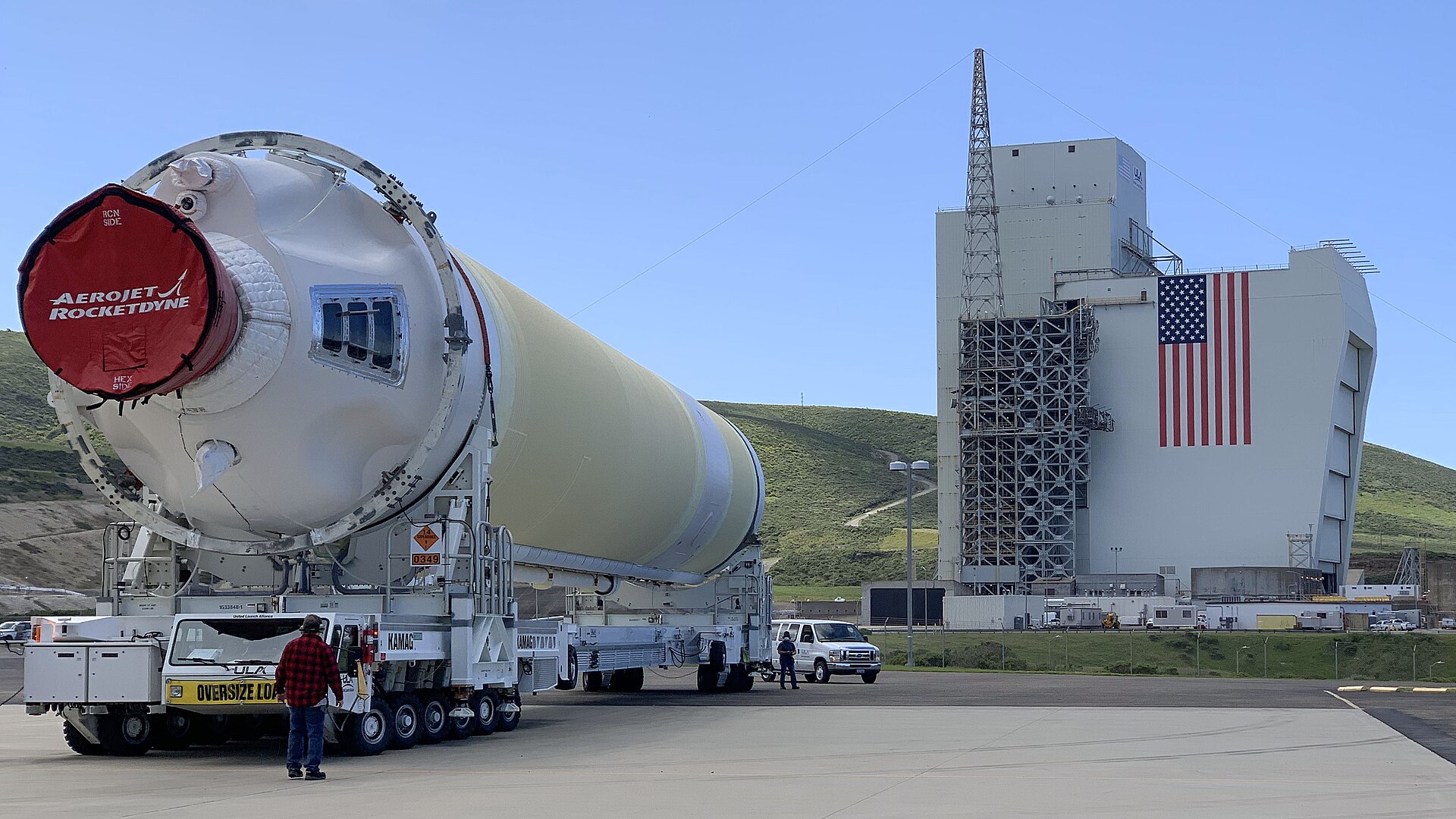 A Delta IV Heavy booster from a United Launch Alliance barge, known as the RocketShip, proceeds to the Horizontal Integration Facility May 4, 2020, at Vandenberg Air Force Base, Calif. A HIF is a building within which the stages of a multistage rocket are brought together before the assembled stack is rolled out to the launch pad or space launch complex and raised into a vertical position for final integration and launch. In this photo, the Space Launch Complex 6 combined Assembly Building/Servi