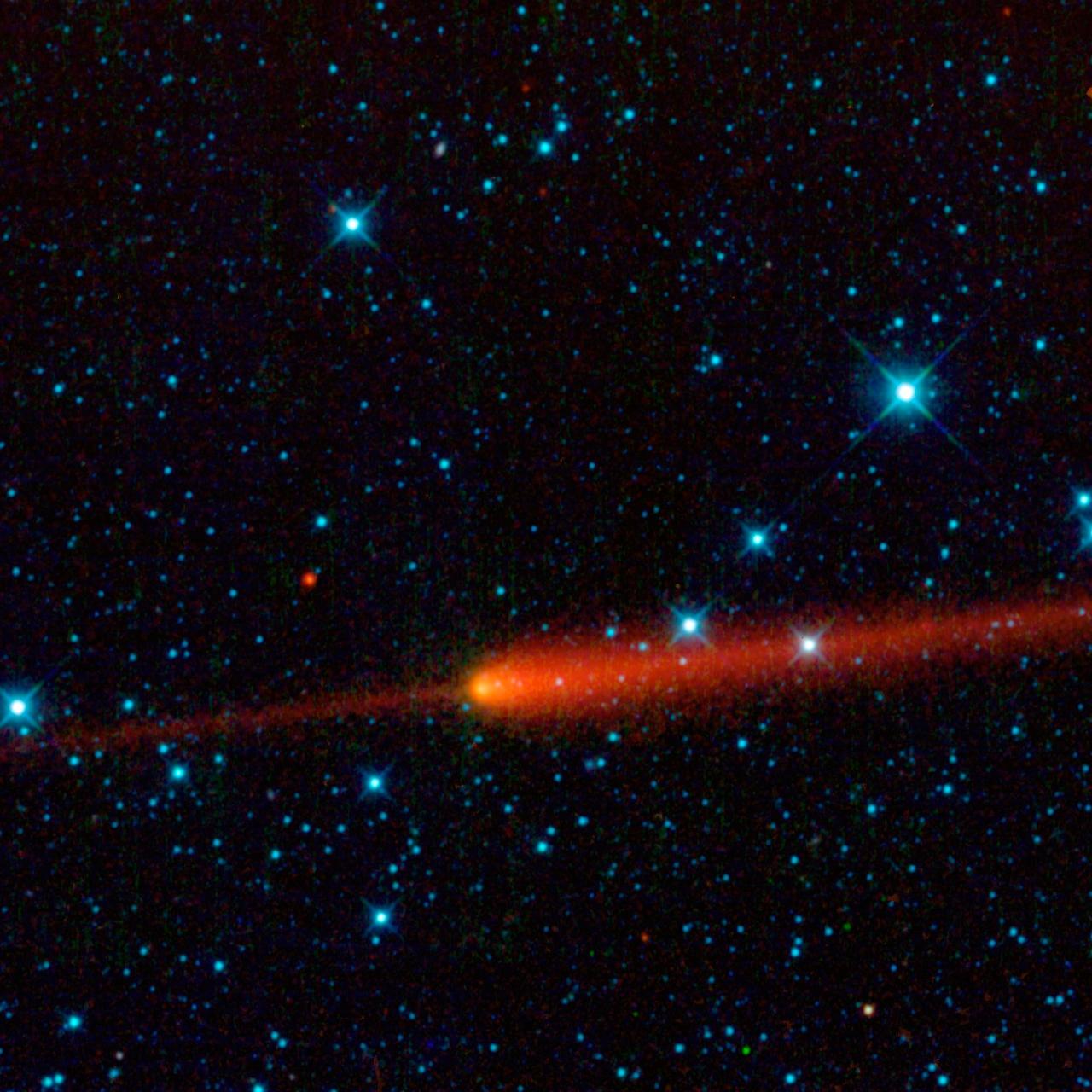 This image from NASA Wide-field Infrared Survey Explorer features comet 65/P Gunn. Comets are balls of dust and ice left over from the formation of the solar system. The comet tail is seen here in red trailing off to the right of the comet nucleus.