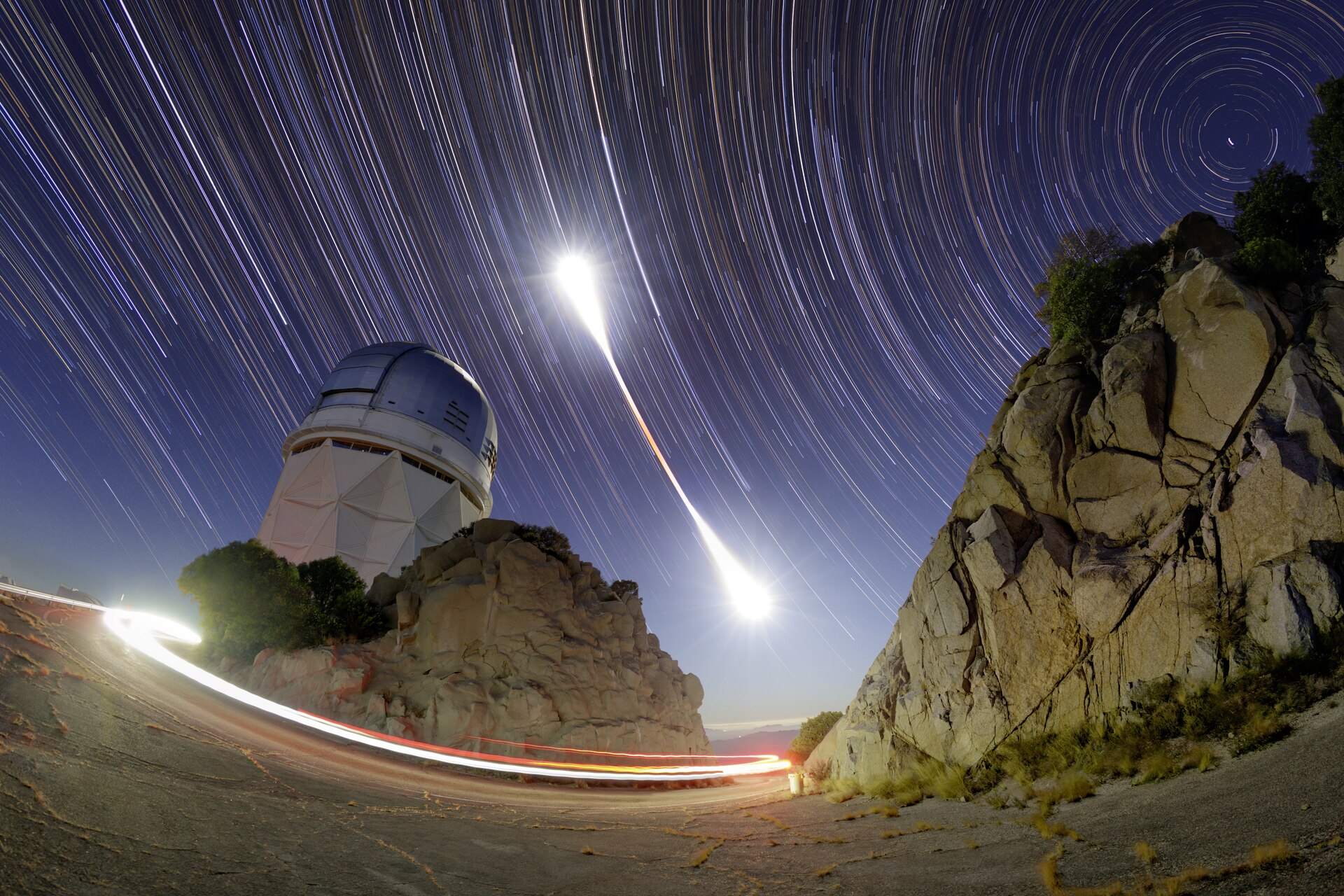 This still image combines hundreds of time-lapse exposures that capture the entirety of the 8 November 2022 total lunar eclipse above the Nicholas U. Mayall 4-meter Telescope atKitt Peak National Observatory, a Program of NSF’s NOIRLab. Lunar eclipses occur when the Moon passes through the shadow of Earth. During a total lunar eclipse, when the whole Moon enters Earth’s shadow, our natural satellite is drenched in red. The period of totality is evident in this image by the red at the center of t