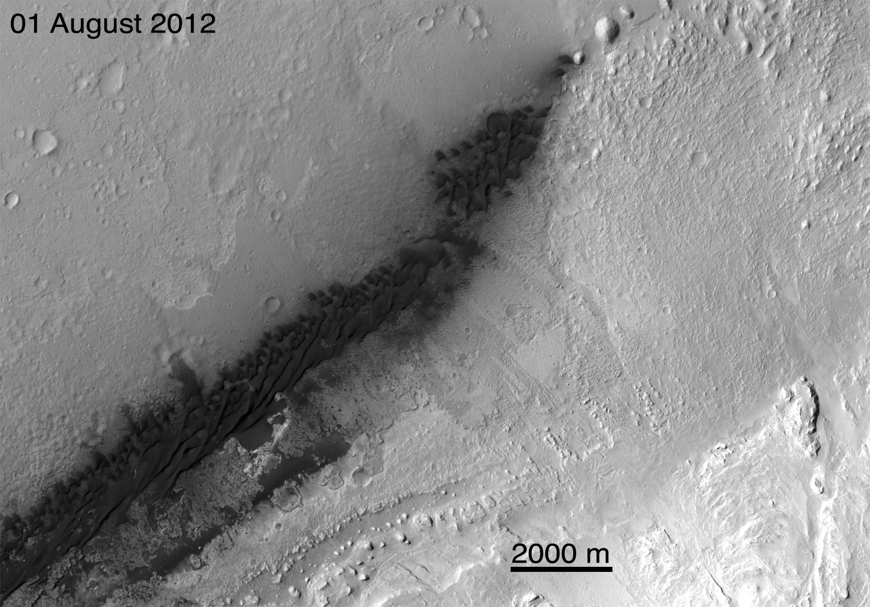 This image from an animation is from NASA Mars Reconnaissance Orbiter MRO showing the landing effects of the descent stage, the rover lander, the back shell and parachute, and the heat shield, all found on the left side of the image.