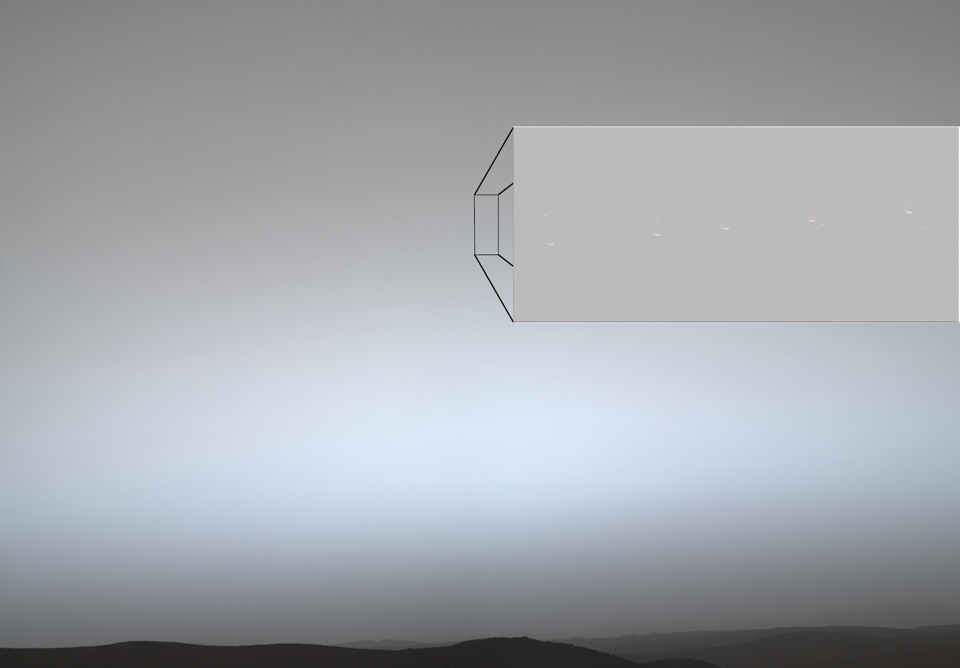 This composite of seven images from the Mastcam-Z instrument aboard NASA’s Perseverance Mars rover shows Earth, visible as a small bright dot moving from upper left to lower right, passing behind the Martian moon Phobos on July 2, 2026, 1,9