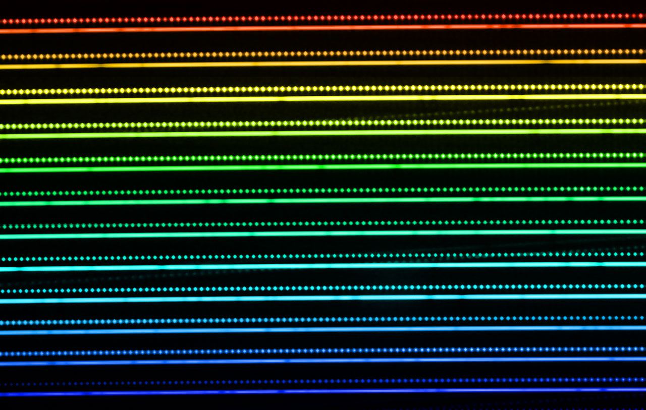 This picture illustrates part of a spectrum of a star obtained using the HARPS instrument on the ESO 3.6-metre telescope at the La Silla Observatory in Chile. The lines are the light from the star spread out in great detail into its component colours. The dark gaps in the lines are absorption features from different elements in the star. The regularly spaced bright spots just above the lines are the spectrum of the laser frequency comb that is used for comparison. The very stable nature and regu