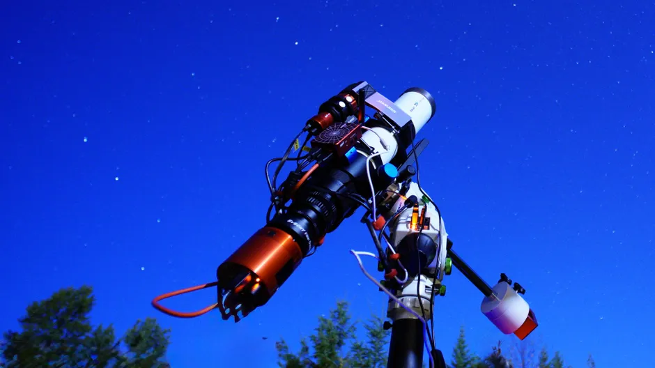 Um telescópio sofisticado apontando para o céu estrelado, perfeito para entusiastas de astronomia.