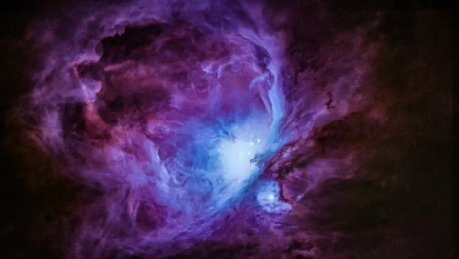 Uma imagem hipnotizante da Nebulosa de Órion mostrando nuvens cósmicas vibrantes e formações estelares.