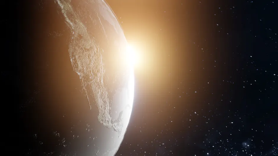 Uma vista deslumbrante da Terra com o sol nascendo, iluminando o planeta no espaço.