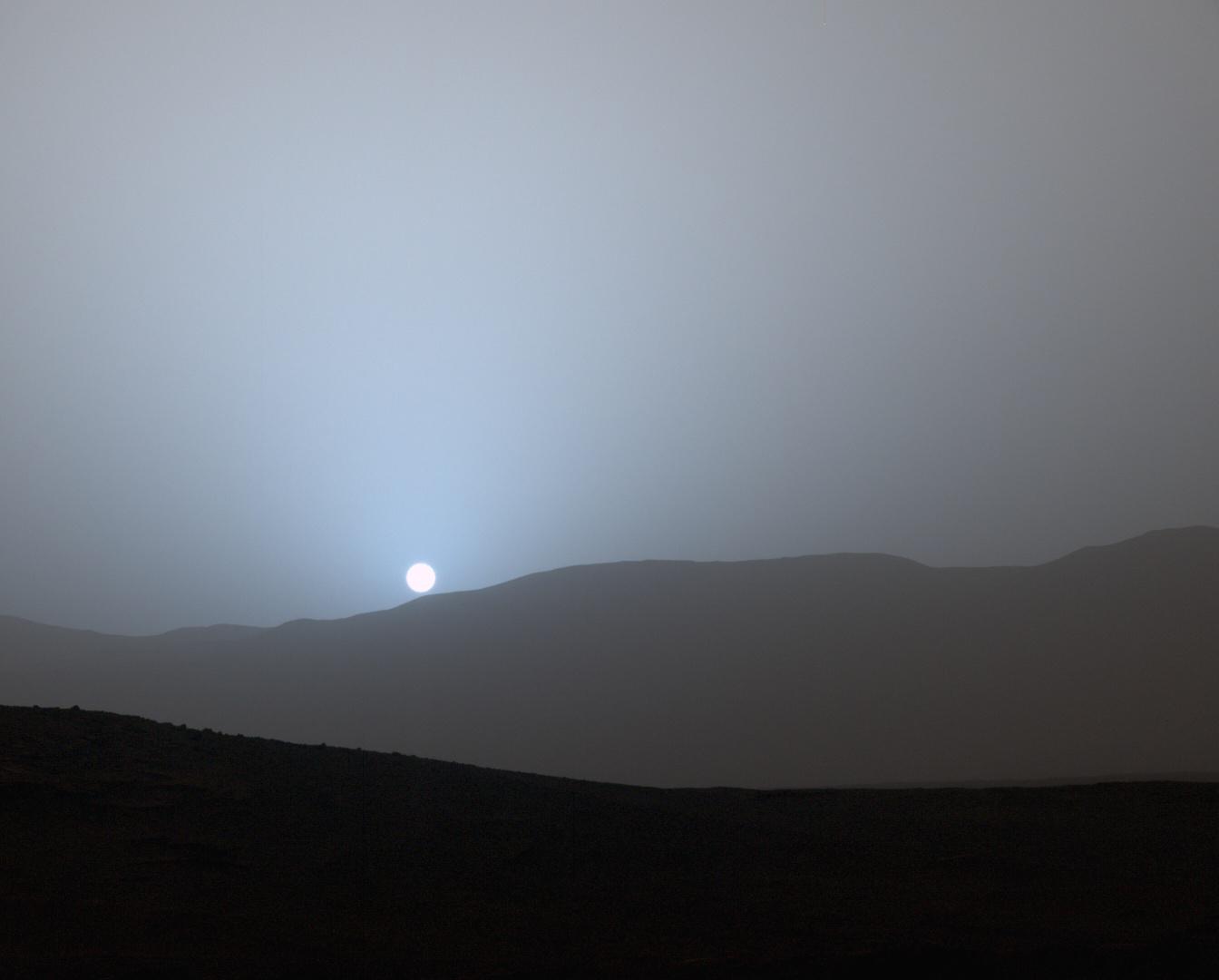NASA Curiosity Mars rover recorded this view of the sun setting at the close of the mission 956th Martian day, or sol April 15, 2015, from the rover location in Gale Crater.